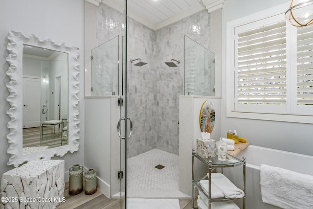 full bathroom with a shower stall, a tub to relax in, and wood finished floors