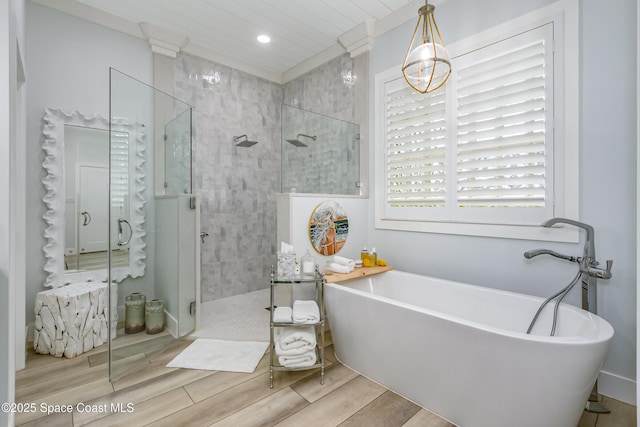 bathroom featuring recessed lighting, wood tiled floor, a shower stall, and a freestanding tub