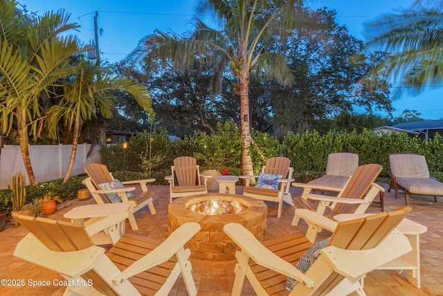 view of patio with a fire pit and fence