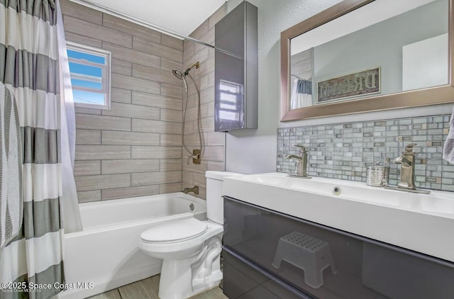 bathroom featuring vanity, toilet, shower / bath combo, and backsplash