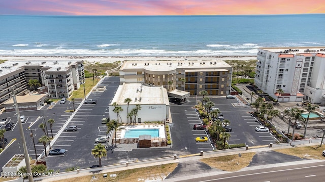 birds eye view of property featuring a view of the beach and a water view