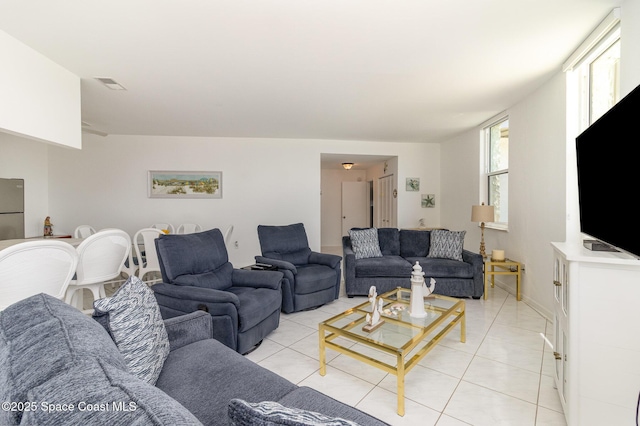 living area with light tile patterned floors and visible vents