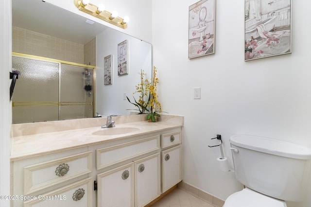 bathroom featuring a shower stall, tile patterned floors, vanity, and toilet