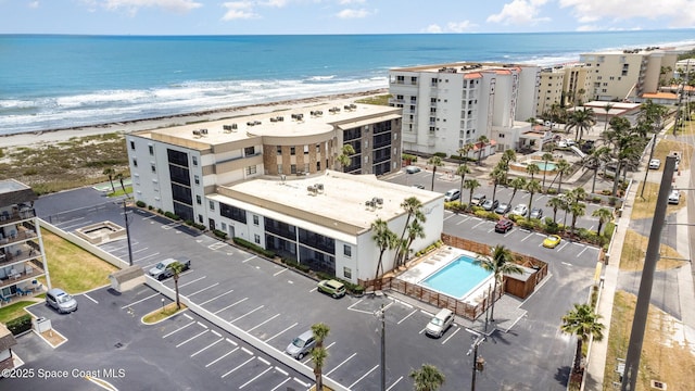 birds eye view of property featuring a beach view and a water view