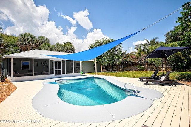 view of swimming pool featuring a sunroom, a fenced backyard, and a deck
