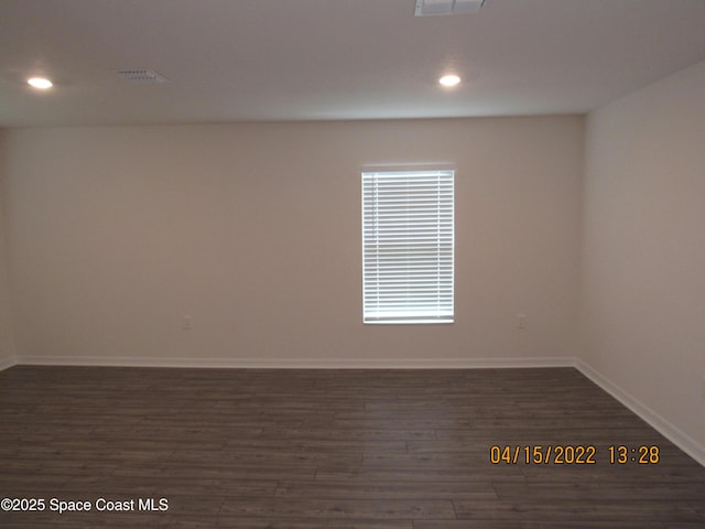 spare room with baseboards, dark wood-style flooring, recessed lighting, and visible vents