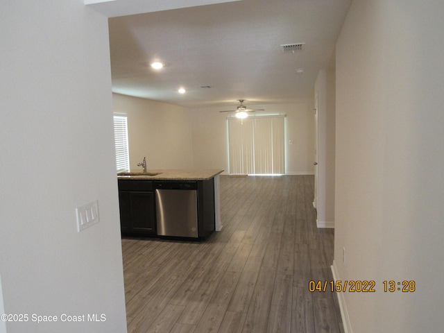 kitchen with wood finished floors, visible vents, ceiling fan, stainless steel dishwasher, and baseboards