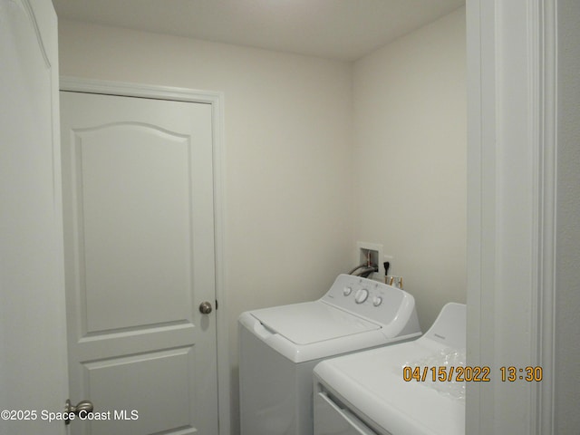 laundry room with washing machine and clothes dryer and laundry area