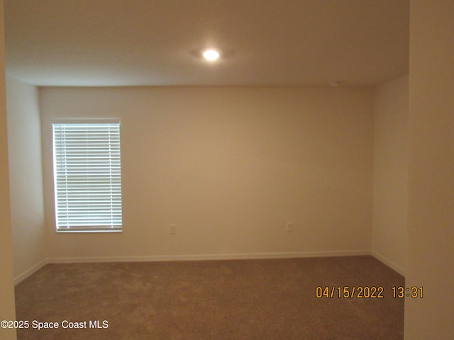 empty room featuring carpet flooring, baseboards, and recessed lighting