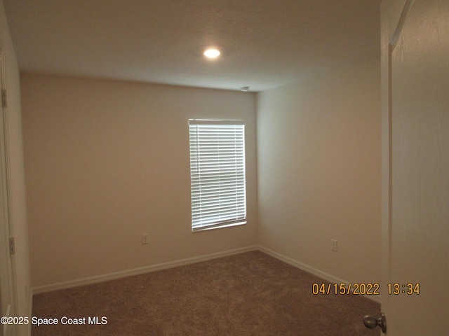 carpeted empty room with baseboards and recessed lighting
