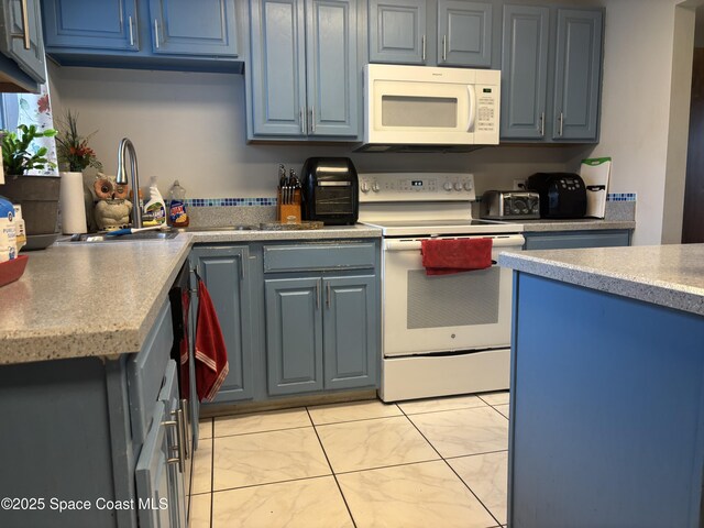 986 Macco Rd, Cocoa, FL 32927 - kitchen featuring white appliances, blue cabinets, and light countertops