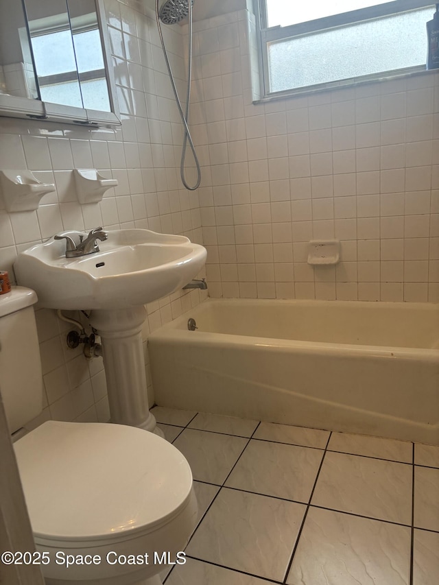986 Macco Rd, Cocoa, FL 32927 - full bath with toilet, tile walls, tile patterned floors, and washtub / shower combination