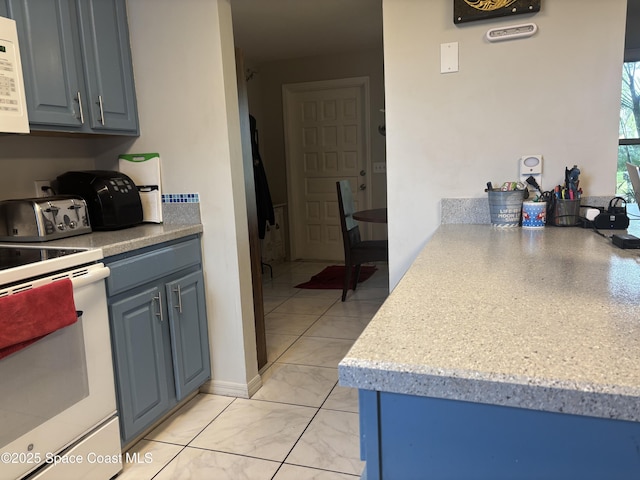 986 Macco Rd, Cocoa, FL 32927 - kitchen with white appliances, light countertops, and blue cabinetry