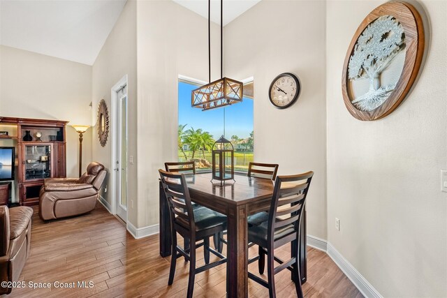 5770 Mascaro Ct, Melbourne, FL 32940 - dining area with wood finished floors, baseboards, and a high ceiling