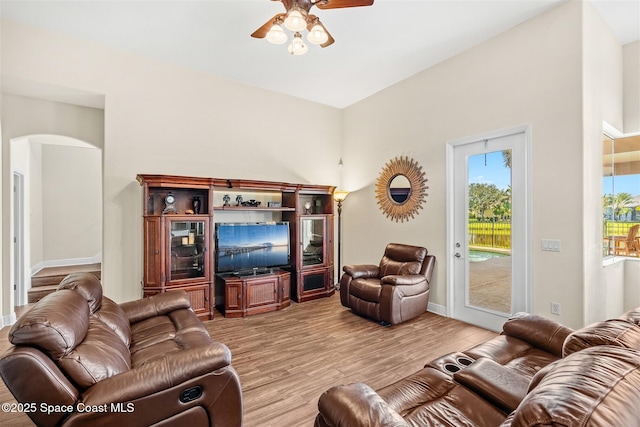 5770 Mascaro Ct, Melbourne, FL 32940 - living area featuring arched walkways, ceiling fan, light wood-style flooring, and baseboards
