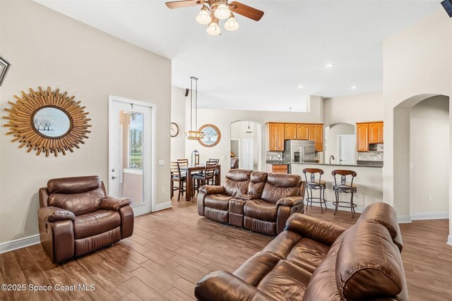 5770 Mascaro Ct, Melbourne, FL 32940 - living area featuring arched walkways, a ceiling fan, and wood finished floors