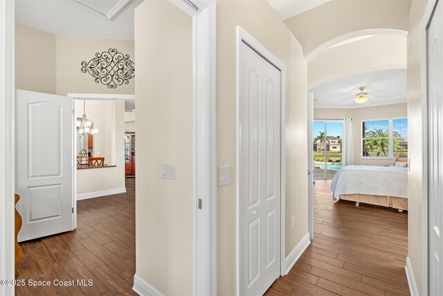 5770 Mascaro Ct, Melbourne, FL 32940 - corridor with dark wood-type flooring, baseboards, and arched walkways