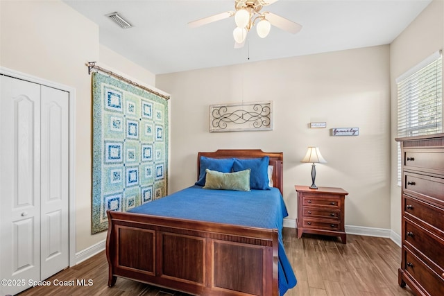 5770 Mascaro Ct, Melbourne, FL 32940 - bedroom with baseboards, wood finished floors, a ceiling fan, and a closet