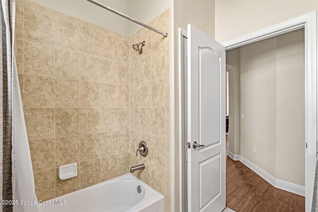 5770 Mascaro Ct, Melbourne, FL 32940 - bathroom featuring wood finished floors, shower / bath combo with shower curtain, and baseboards