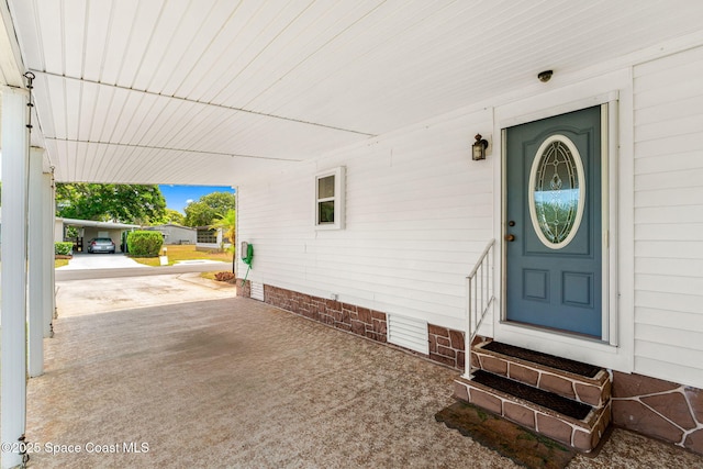 view of exterior entry featuring an attached carport