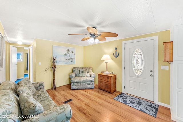 foyer entrance featuring light wood-type flooring, visible vents, and ceiling fan