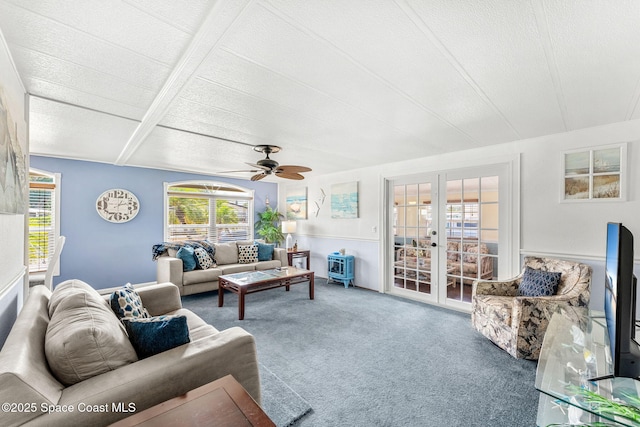 living area with a ceiling fan, plenty of natural light, french doors, and carpet floors
