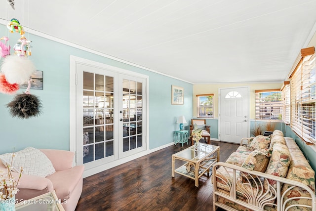 living room featuring a wealth of natural light, french doors, crown molding, and wood finished floors