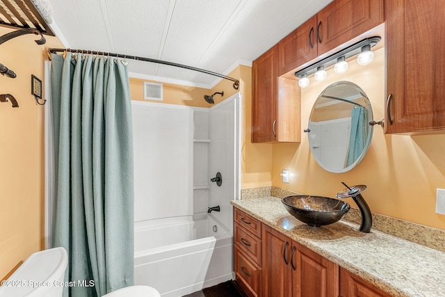 bathroom featuring toilet, vanity, ornamental molding, visible vents, and shower / bath combo