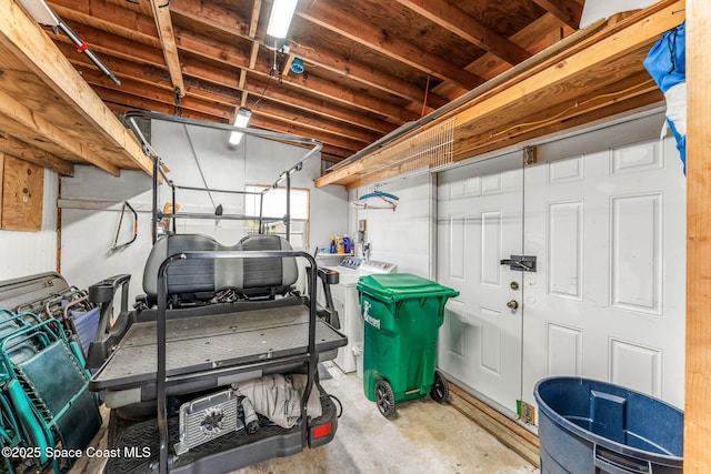 below grade area featuring separate washer and dryer and a garage