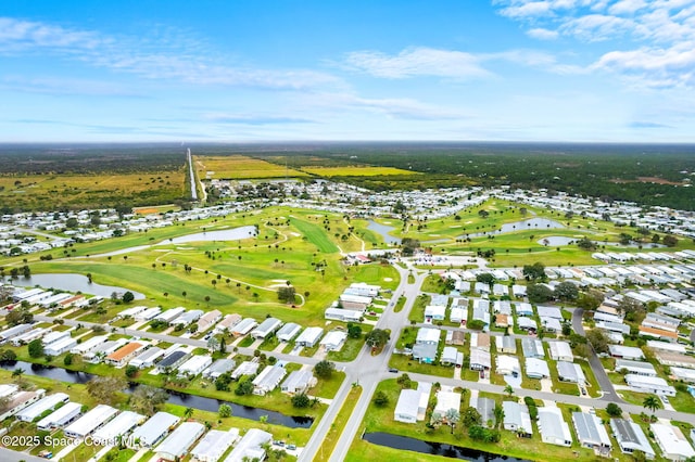 birds eye view of property featuring view of golf course, a water view, and a residential view