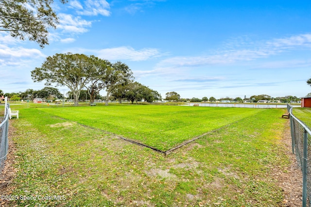 view of yard with fence and a water view