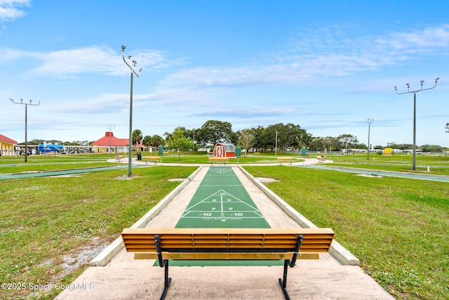 surrounding community featuring a yard and shuffleboard