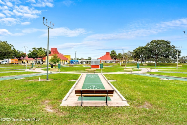 view of community featuring a yard and shuffleboard