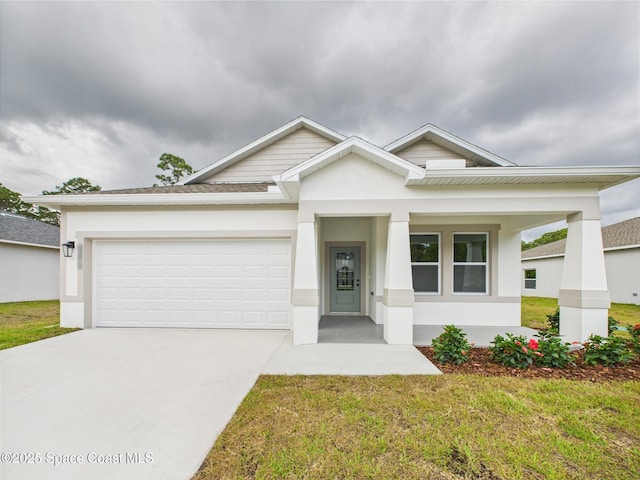 view of front of house featuring an attached garage, stucco siding, concrete driveway, a front lawn, and a porch