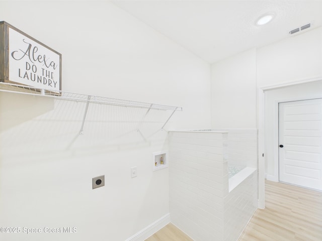 laundry area with hookup for a washing machine, visible vents, light wood-style floors, laundry area, and electric dryer hookup