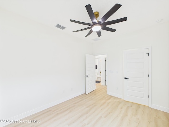 unfurnished bedroom featuring light wood-style flooring, baseboards, a ceiling fan, and visible vents