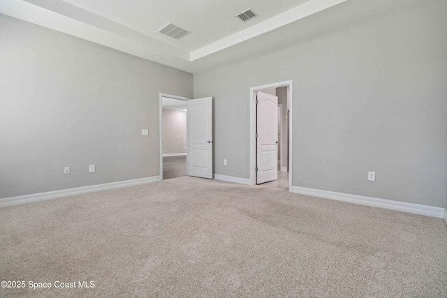 780 Geddes St SW, Palm Bay, FL 32908 - unfurnished bedroom featuring light carpet, a towering ceiling, baseboards, and connected bathroom