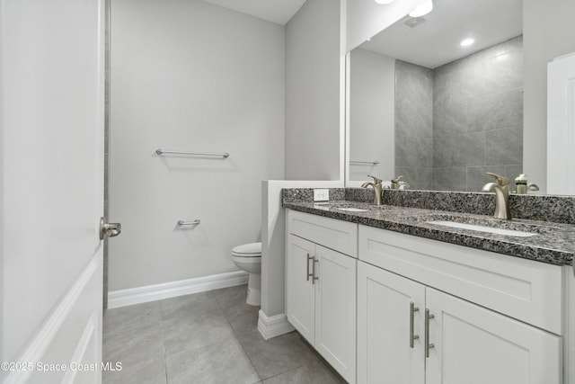 780 Geddes St SW, Palm Bay, FL 32908 - bathroom featuring toilet, double vanity, baseboards, and tile patterned flooring