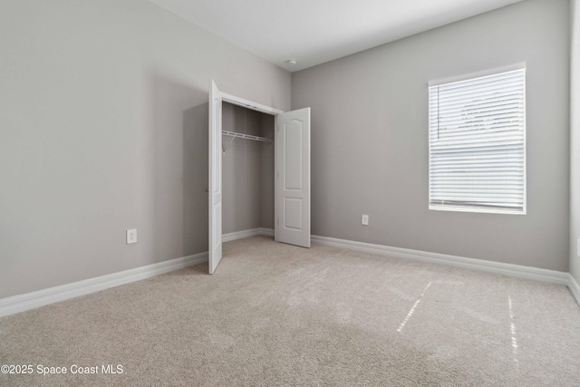 780 Geddes St SW, Palm Bay, FL 32908 - unfurnished bedroom featuring light carpet, a closet, and baseboards
