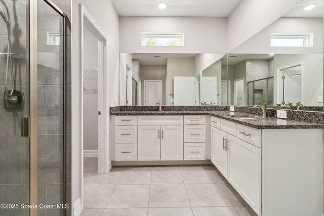 780 Geddes St SW, Palm Bay, FL 32908 - full bathroom with a shower stall, tile patterned floors, vanity, recessed lighting, and a closet