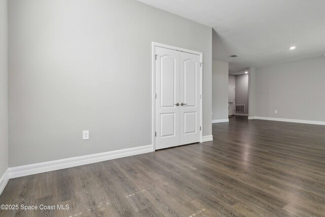 780 Geddes St SW, Palm Bay, FL 32908 - empty room with dark wood-style floors, baseboards, and recessed lighting