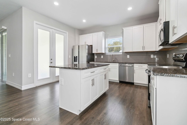 780 Geddes St SW, Palm Bay, FL 32908 - kitchen with stainless steel appliances, dark wood-style floors, tasteful backsplash, recessed lighting, and a kitchen island