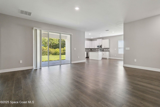 780 Geddes St SW, Palm Bay, FL 32908 - unfurnished living room with baseboards, dark wood-type flooring, and recessed lighting