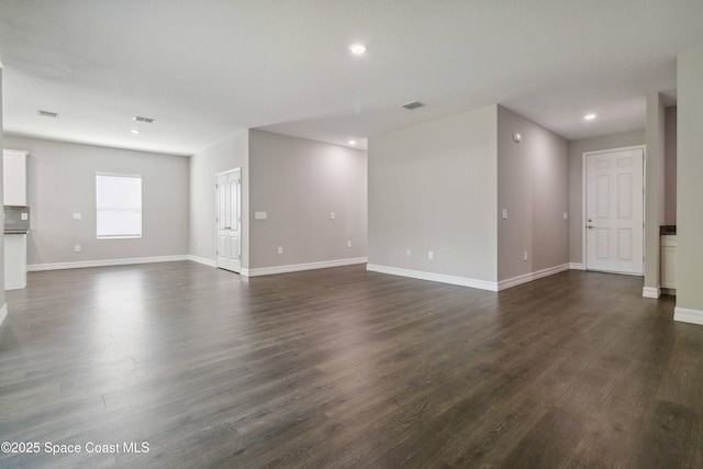 780 Geddes St SW, Palm Bay, FL 32908 - unfurnished living room featuring dark wood-style flooring, recessed lighting, and baseboards