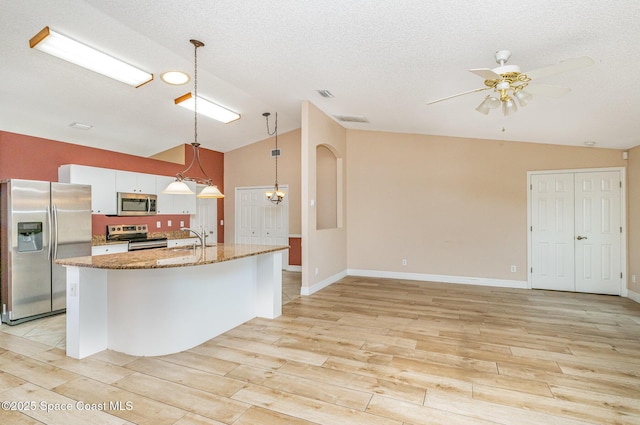 766 Preakness Dr, Melbourne, FL 32904 - kitchen with a sink, stainless steel appliances, vaulted ceiling, a ceiling fan, and light wood-style floors