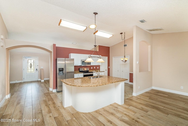 766 Preakness Dr, Melbourne, FL 32904 - kitchen featuring an island with sink, light wood-style flooring, appliances with stainless steel finishes, and a sink