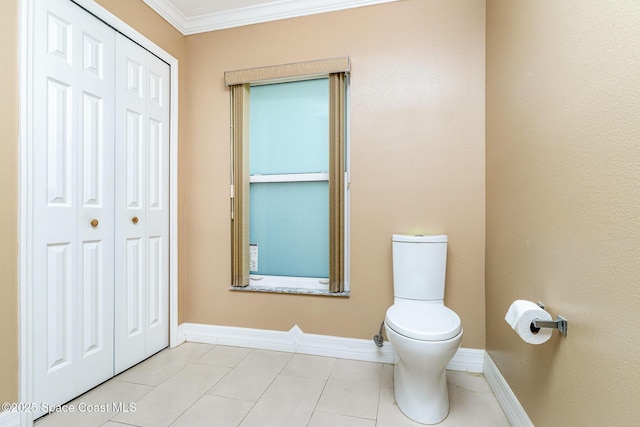 766 Preakness Dr, Melbourne, FL 32904 - bathroom with toilet, baseboards, tile patterned floors, and crown molding