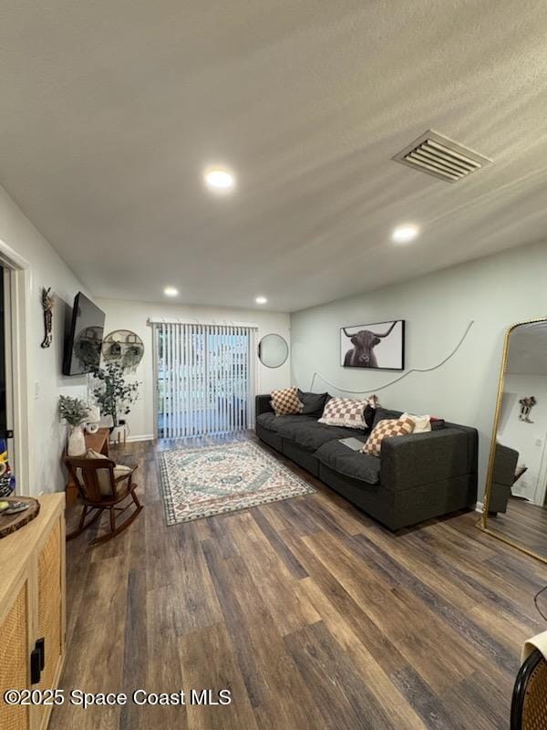 living area featuring visible vents, wood finished floors, and recessed lighting