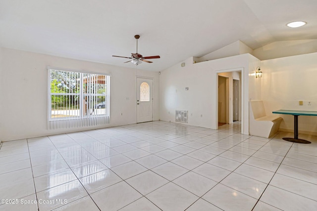 unfurnished room with lofted ceiling, light tile patterned floors, and ceiling fan