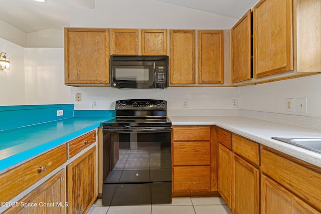 kitchen featuring black appliances, lofted ceiling, light tile patterned floors, brown cabinets, and light countertops